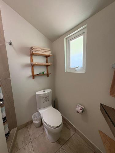a bathroom with a toilet and a window at Privada 400 in Pachuca de Soto