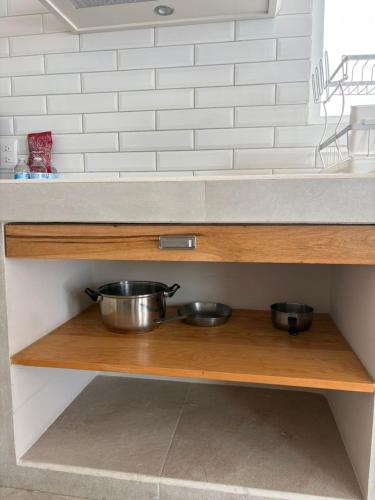 two bowls on a wooden shelf in a kitchen at Privada 400 in Pachuca de Soto