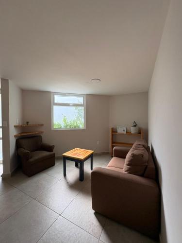 a living room with a couch and a table at Privada 400 in Pachuca de Soto