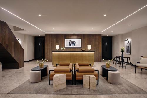 a lobby with chairs and a bar in a building at Isabella by Viadora in Mexico City