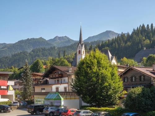 a small town with a church and a parking lot at Chalet Hornblick in Fieberbrunn