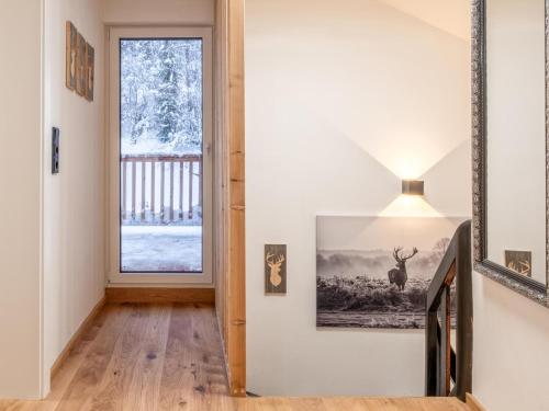 a hallway with a window and a picture on the wall at Chalet Hornblick in Fieberbrunn