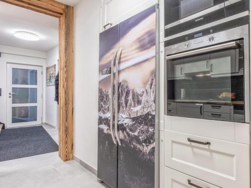 a kitchen with a microwave and a wall at Chalet Hornblick in Fieberbrunn