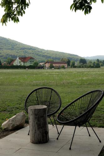 two park benches sitting next to a tree stump at O'Toole's, Plitvice in Korenica