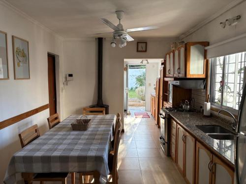 a kitchen with a table with a table cloth on it at Casa Rita in Gualeguaychú