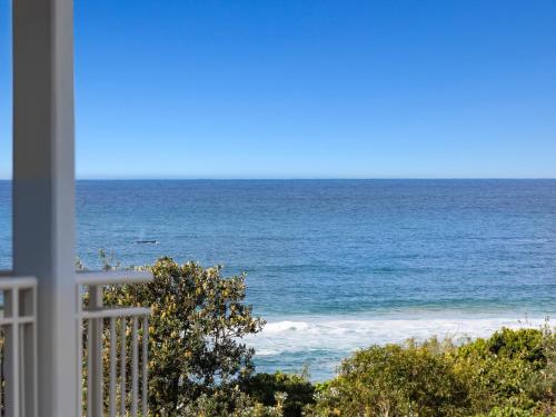 a view of the ocean from a balcony at The Pool Resort Kingscliff - Private Apartments by Holiday Management Company in Kingscliff