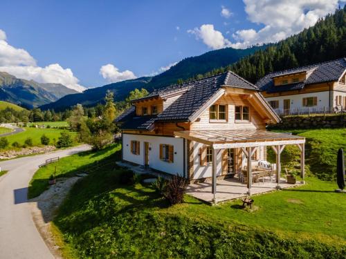 a house in the mountains with a porch at Chalet Amsel in Donnersbachwald