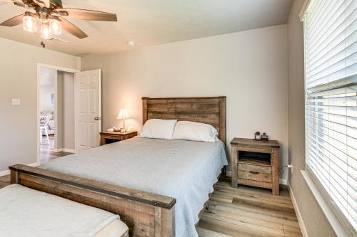 a bedroom with a bed and a table with a lamp at 9 Mi to College Station Dog-Friendly Home with Yard in Bryan