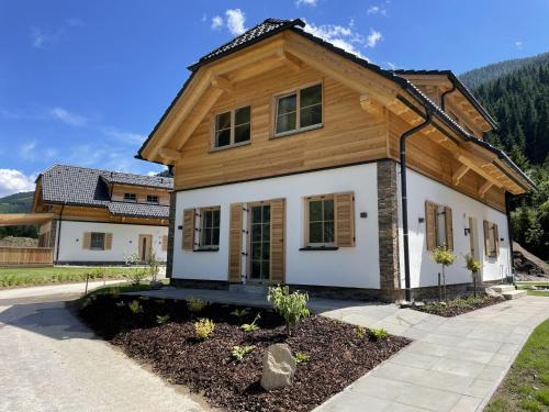 a house with a wooden roof at Donnersbach Lodge in Donnersbachwald