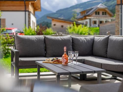 a bottle of alcohol sitting on a table with glasses at Donnersbach Lodge in Donnersbachwald