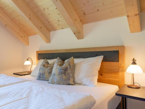 a bedroom with a white bed with pillows at Apart Heidi in Donnersbachwald
