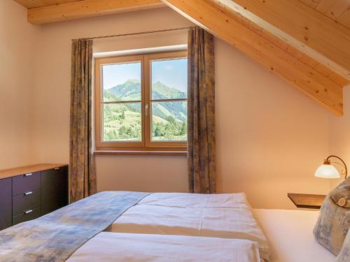 a bedroom with a bed and a window at Apart Heidi in Donnersbachwald