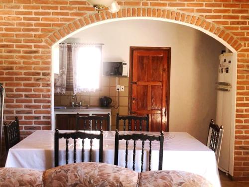 a dining room with a table and a brick wall at Exclusivo chalet a 250 metros del mar in Mar de Ajó