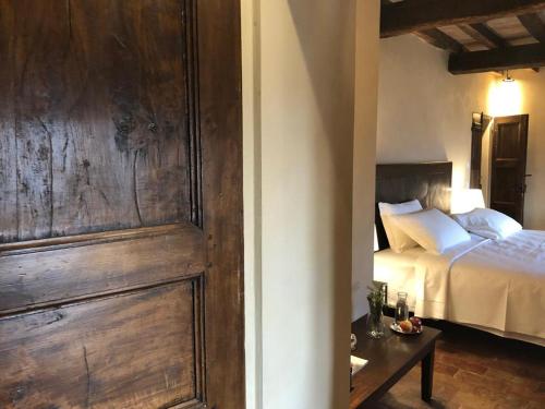 a bedroom with a bed and a wooden wall at Castello di Viano in Viano