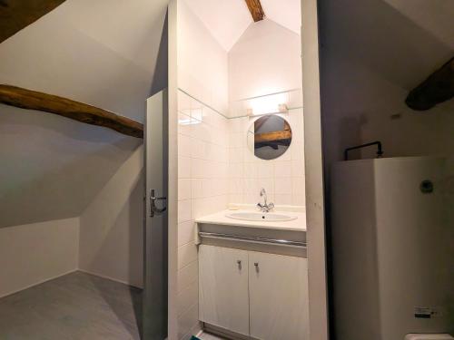 a bathroom with a sink and a refrigerator at Maison de vacances en Brenne avec piscine partagée, grand jardin et tout confort inclus - FR-1-591-329 in Bélâbre