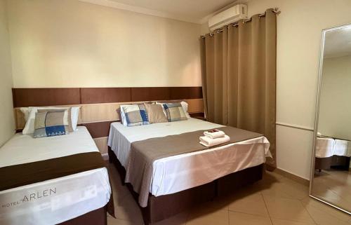 a hotel room with two beds with towels on them at Pousada Castelo in Careaçu