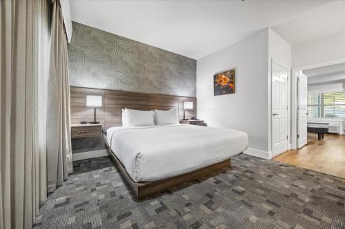 a bedroom with a large bed in a room at University Park Inn & Suites, an Ascend Collection Hotel in Davis