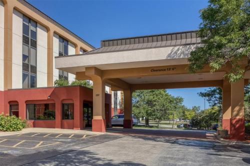 a building with a parking lot in front of it at SureStay Plus Hotel by Best Western Chicago Lombard in Lombard