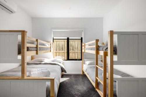 a bedroom with two bunk beds and a window at San Remo Luxe 2 in San Remo