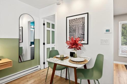 a dining room with a table and green chairs at King Bed, Walk or Bike to town, EV, Pets OK in Ellicottville