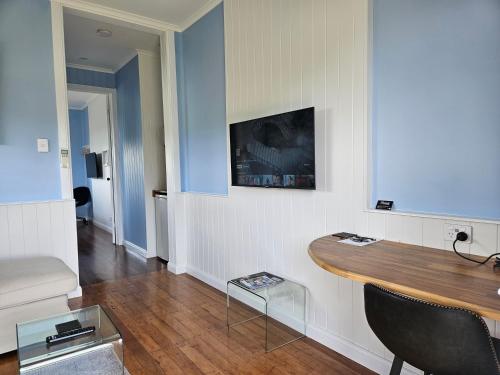 a living room with a table in a room at Kernow - Minimum age 18 in Charters Towers