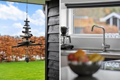 a kitchen sink with a kitchenaucet and a bowl of fruit at OH534-Hadsund-Haslevgarde-Eng-2 in Hadsund