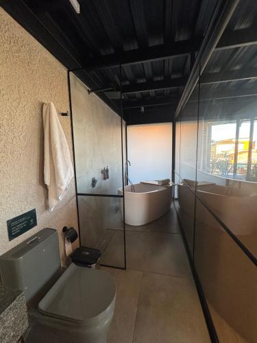 a bathroom with a toilet and a sink and a tub at Hotel Casa Leon Rooftop in Rionegro