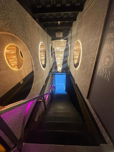 a staircase in a building with purple lights at Hotel Casa Leon Rooftop in Rionegro