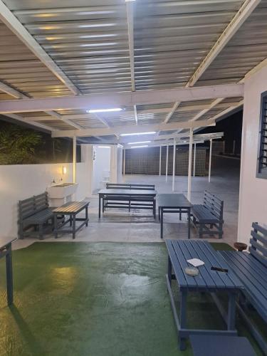 a room with benches and tables in a building at Mead Road Homestay Tours & Transfers Studio in Suva