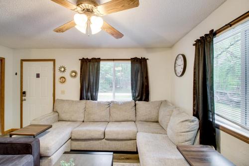 a living room with a couch and a ceiling fan at Near Lakes Updated Family Home with Deck in Cushing in Lincoln