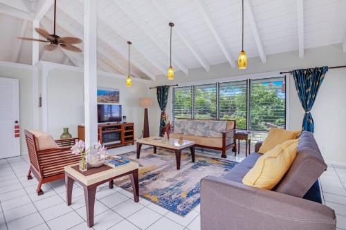 a living room with a couch and a table at Big Island Retreat - No Resort Fees in Kailua-Kona