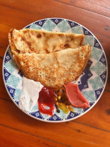 a plate with a piece of toast on a table at Pousada Bate Vento in Itarema