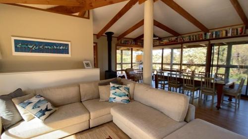 a living room with a couch and a dining room at Beonne the Bay at Vivonne Bay, Kangaroo Island in Vivonne Bay