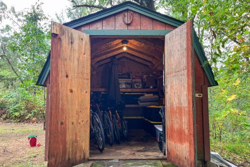 a wooden out house with a bunch of bikes in it at Timber Haven Aframe Cabin - Brand New Hot Tub in Friendship