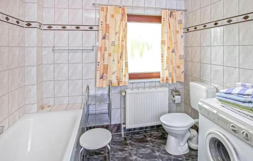 a bathroom with a tub and a toilet and a sink at Ferienwohnung Zislow in Zislow