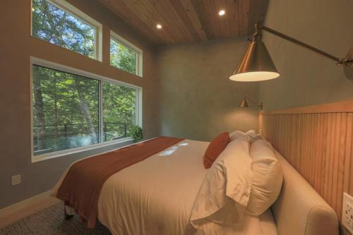 a bedroom with a bed and a large window at Cozy Luxury Cabin w Hot Tub, Fire Pit, King Bed in Newry