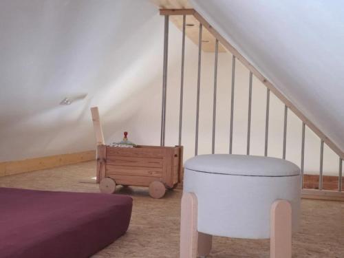 a room with a bed and a wooden chest next to stairs at Holiday home in Oelsnitz with swimming pool in Hohekreuz