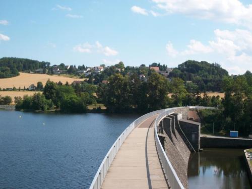 a bridge over a body of water at Holiday home in Oelsnitz with swimming pool in Hohekreuz