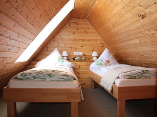 two twin beds in a wooden attic bedroom at 4 people North Sea East Frisian in Borkum