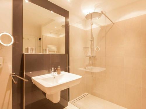 a bathroom with a sink and a shower at One-bedroom apartment in Sassnitz