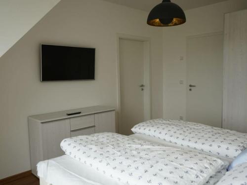 a bedroom with a bed and a tv on the wall at Holiday home in Vaschvitz with sauna in Vaschvitz