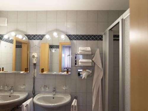 a bathroom with two sinks and two mirrors at Apartment in Vienna with 1 bedroom in Vienna