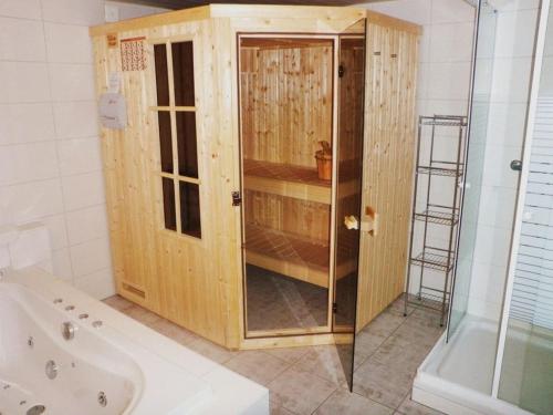 a bathroom with a shower and a wooden cabinet at Holiday home with 2 bedrooms in Im Esch