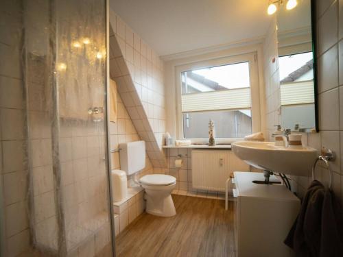 a bathroom with a toilet and a sink and a shower at -CANCER- in the -muschelsöker- in Langeoog