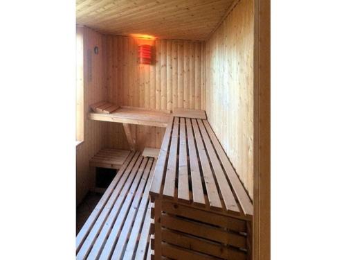 a wooden sauna with a bench in it at Storchensicht - Apartment with sauna in Losentitz