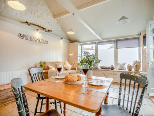 a dining room with a wooden table and chairs at The Old Candle Shop in Little Walsingham