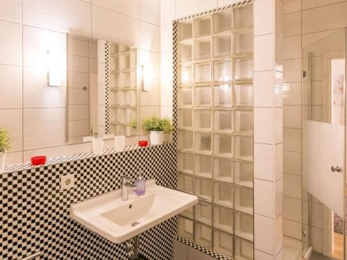 a bathroom with a sink and a mirror at Family accommodation in Dresden