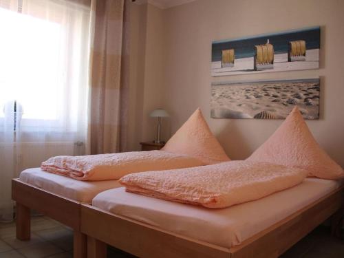 a bedroom with two beds and a window at One-bedroom apartment in Borkum