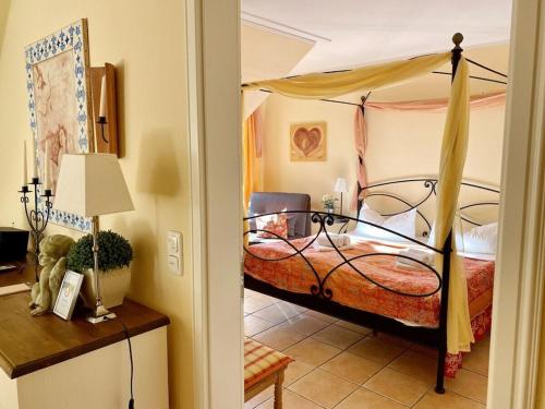 a bedroom with a bed with a canopy at Wellness Residence Apartment 12 in Zingst