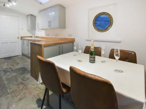 a kitchen with a table with wine glasses on it at The Cliff in Ellon